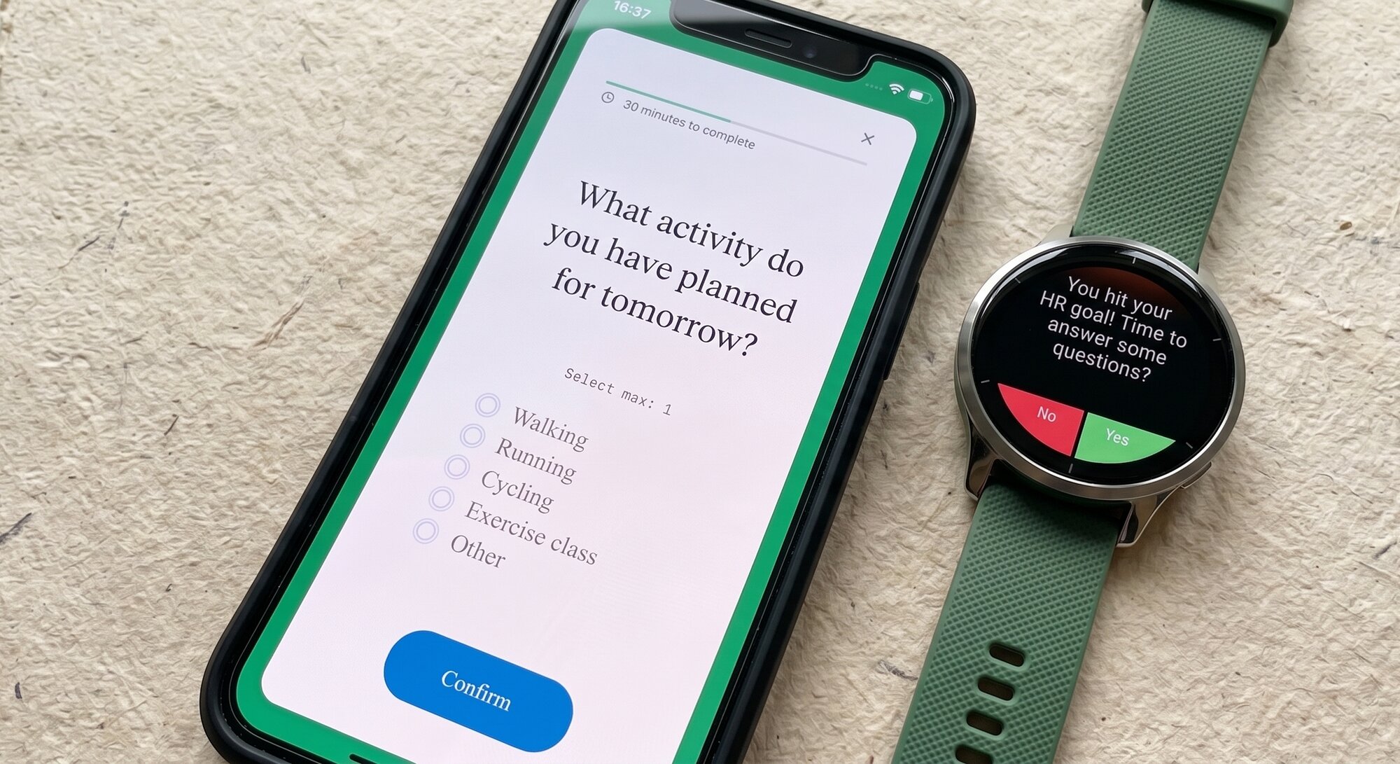 Fitabase Engage mobile app and smartwatch shown on a warm editorial flat lay